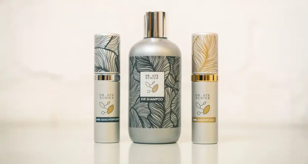 Three cosmetic products by Dr. Ute Schick—facial care, shampoo, and eye care—stylishly arranged side by side.